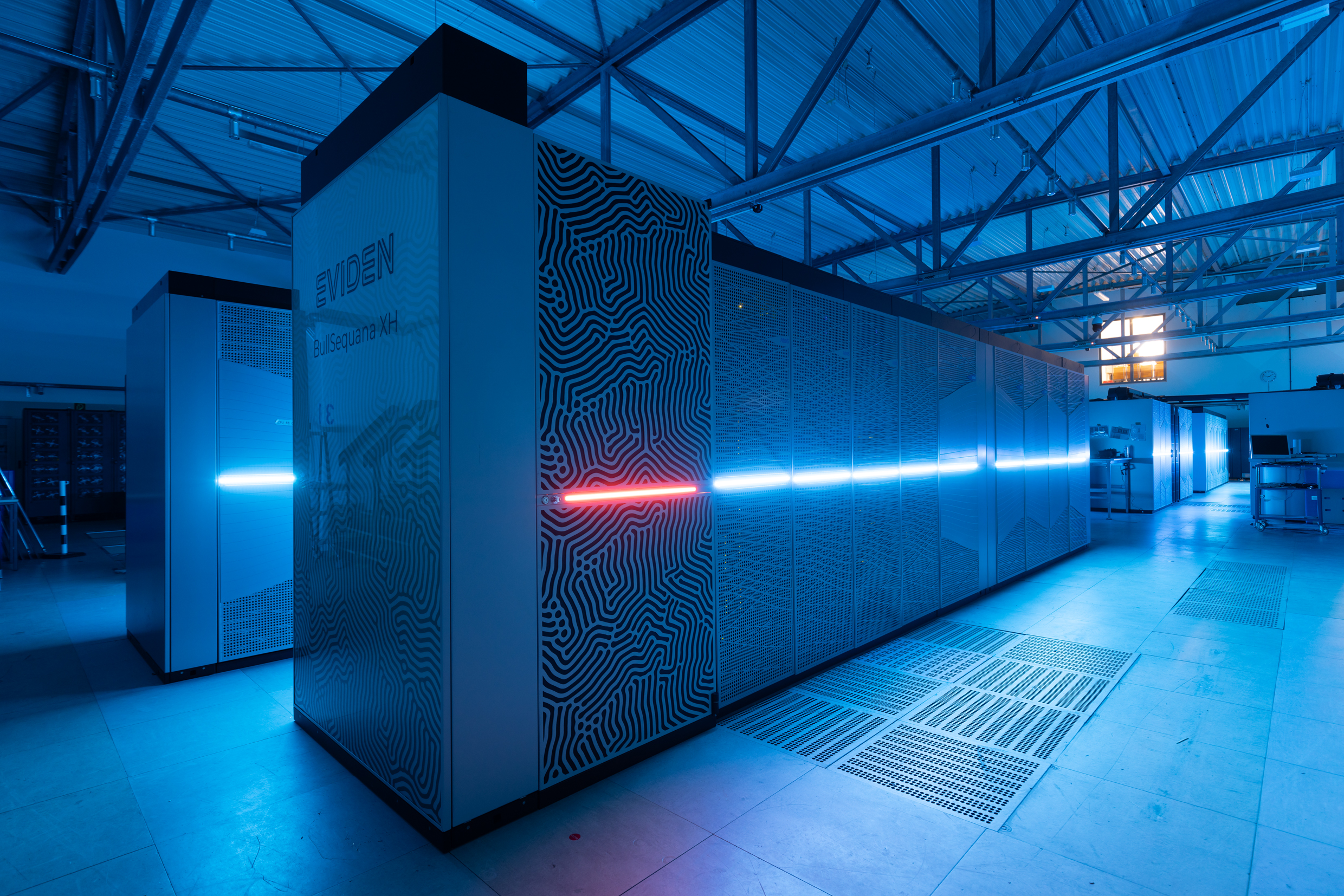 A supercomputer at Forschungszentrum Jülich, blue lighting enhances the spectacular appearance of the computer.