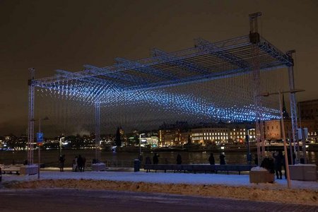 luminous art installation against the backdrop of Stockholm at night