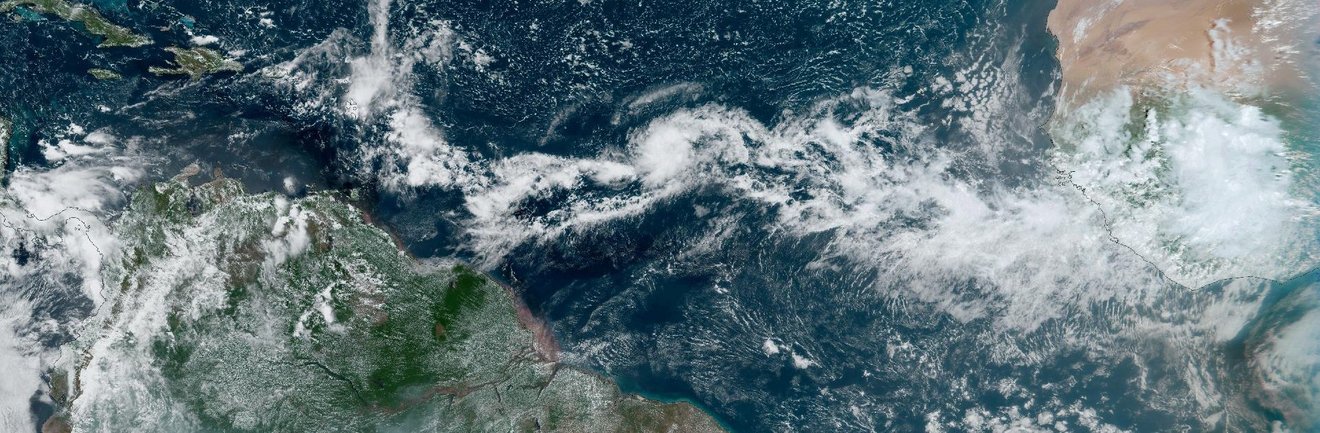 A view of Earth from space showing parts of Africa, Central and South America. A band of clouds wraps around the earth close to the equator.