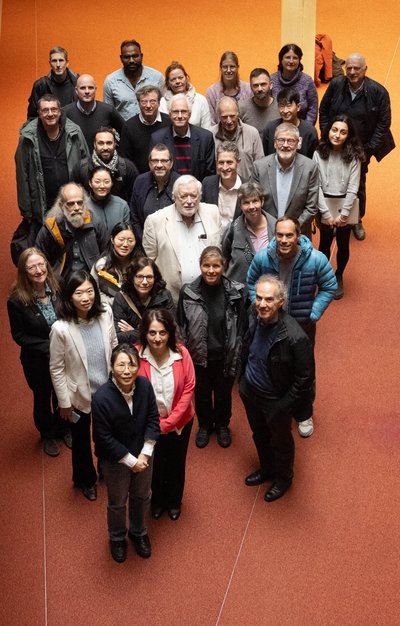 A group of scientists is gathered in front of a seminar room at the Max Planck Institute for Meteorology.